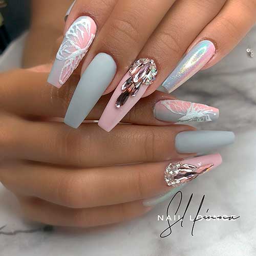 Cute coffin shaped matte grey and pink nails with rhinestones, accent butterfly nail and accent holographic nail design