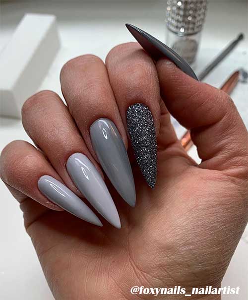 Gorgeous light and medium grey acrylic nails stiletto shaped design with grey glitter nail!