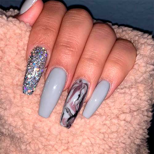 Light gray coffin shaped nails with an accent marble nail and silver glitter nail!