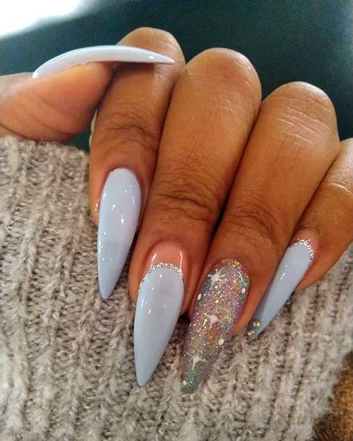 Light gray stiletto nails set with an accent glitter nail which, adorned with snowflakes!