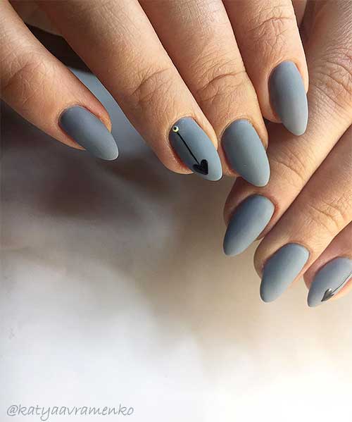 One of the best matte valentines grey nail designs that almond shaped with black heart on accent nail One of the best matte valentines grey nail designs that almond shaped with black heart on accent nail