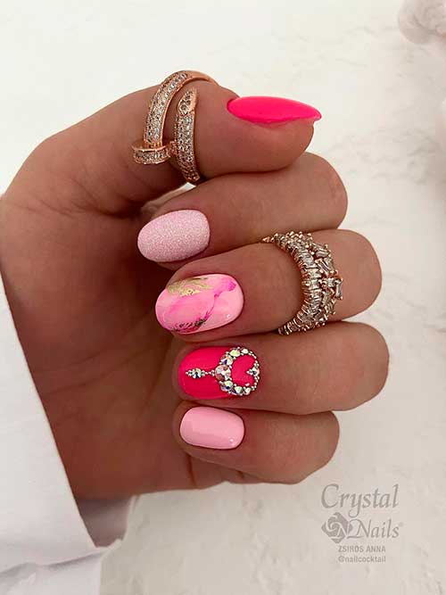Short pastel and hot pink valentine gel nails 2023 rhinestones, glitter, and gold foil