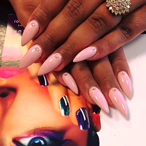 Beautiful baby pink almond nails adorned with a single crystal