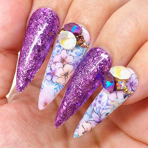 purple floral spring stiletto nails that use dailycharme foil transfer gel floral bundle, crystals, and purple metallic rapunzel glitter
