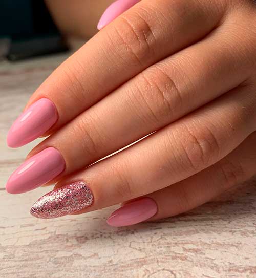 Cute baby pink almond shaped nails with accent glitter nail design!