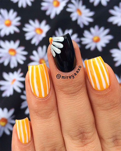 white strips yellow spring nails and white flower on accent black nail