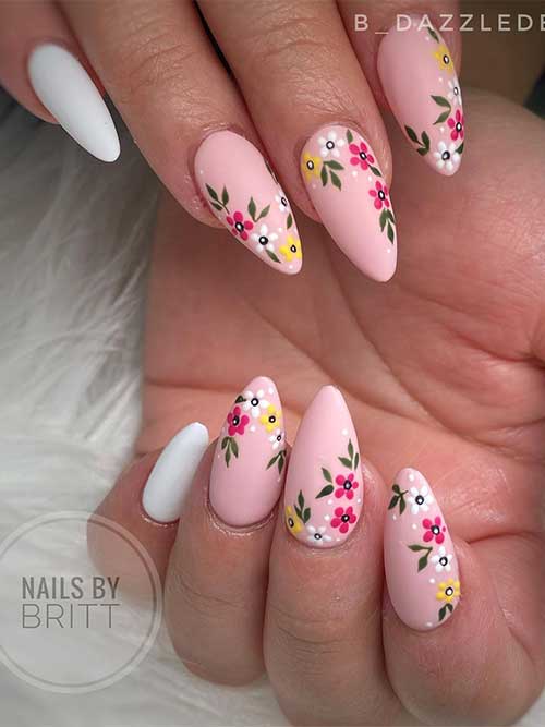 Floral light pink almond nails 2023 with a white accent nail for springtime
