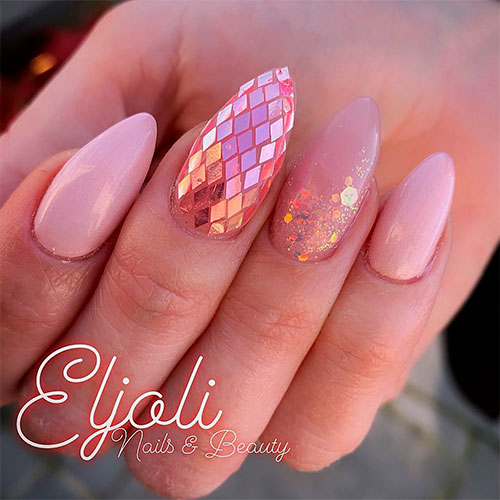 Gorgeous almond light pink nails with gold glitter and metallic flakes