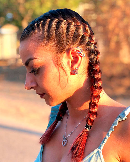 Stylish girl with French Pigtail Braids and ear earrings