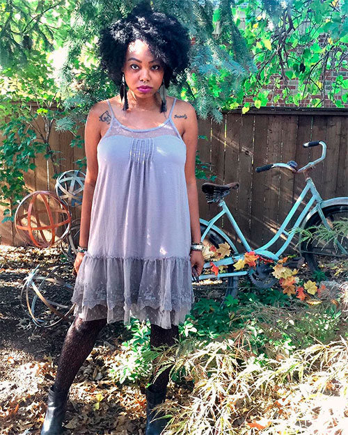 light mauve lace hem slip dress on a black woman at the backyard garden