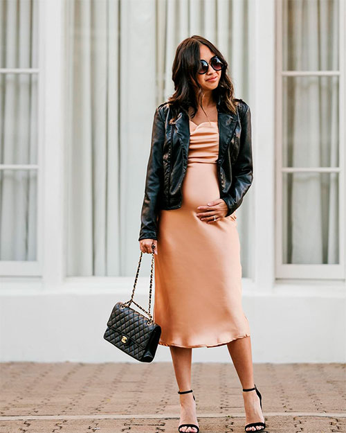 Slip dress is worn under a black leather jacket suit pregnant women in spring 2019