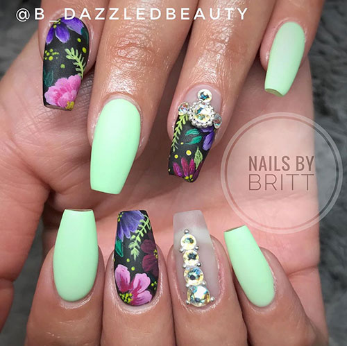 mint green spring coffin nails and floral nails coffin shaped with a black base coat with some rhinestones