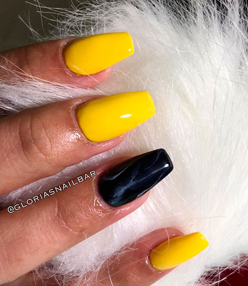 Cute shine yellow coffin nails with an accent black marble nail
