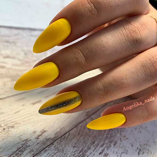 Cute yellow nails almond shape with accent glitter strip nail design! Cute yellow nails almond shape with accent glitter strip nail design!