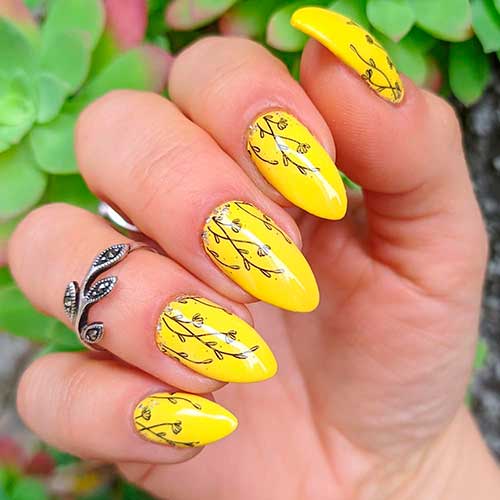 One of the cutest yellow nail designs that consists of yellow almond nails with blossom flowers! 
