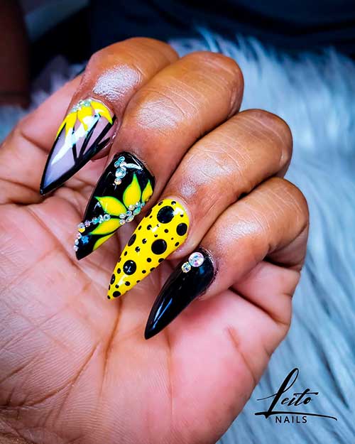 one of the cutest sunflower nail designs that consists of black and yellow nails stiletto shaped! one of the cutest sunflower nail designs that consists of black and yellow nails stiletto shaped!