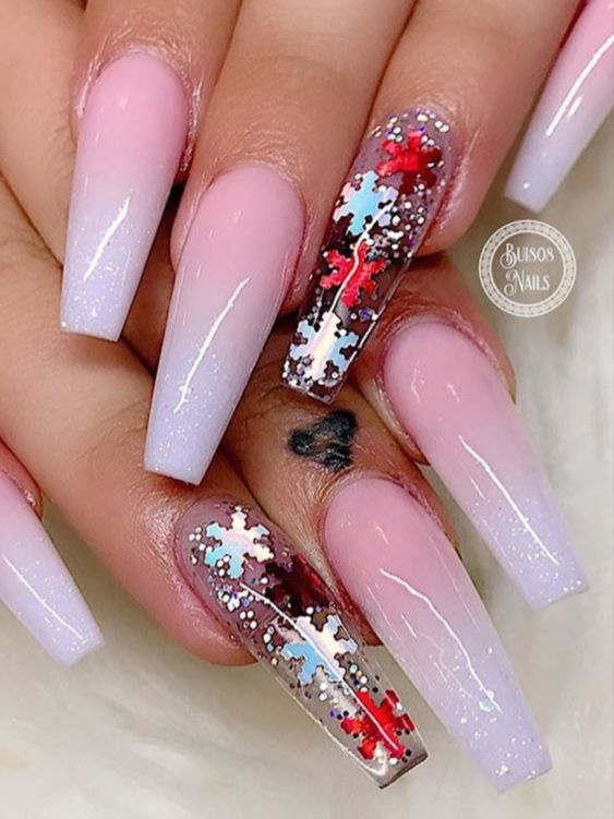 pink and white ombre nails with snow flakes encapsulated glitter on clear accent nail.