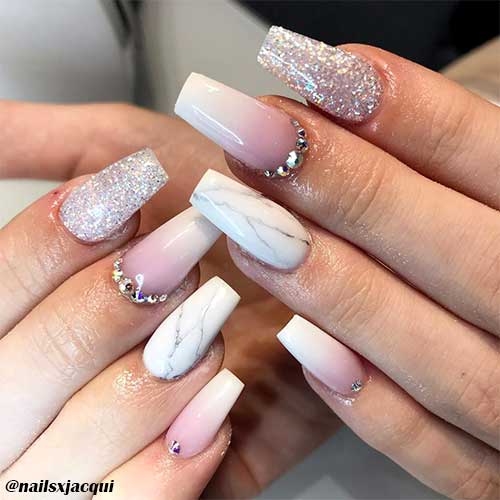 Cute ombre french nails coffin shaped with rhinestones and two accent glitter and white marble nails.
