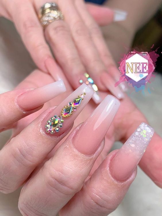 French ombre dip nails with glitter and rhinestones on accent nail. French ombre dip nails with glitter and rhinestones on accent nail.