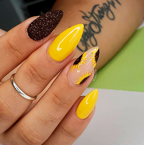 Cute almond sunflower nails with an accent black glitter nail