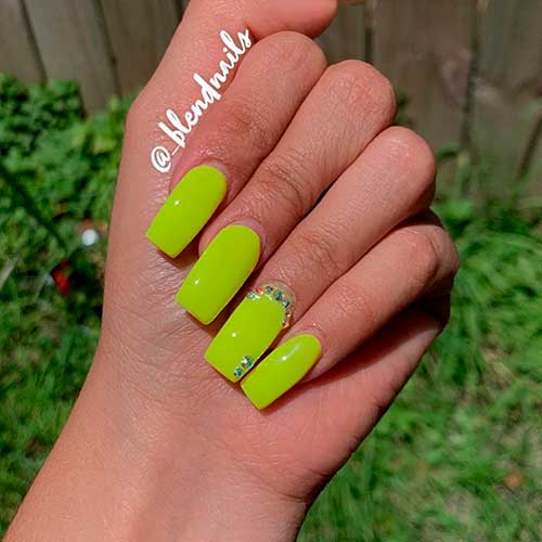 Cute slime green acrylic nails square shaped with rhinestones on accent nail!