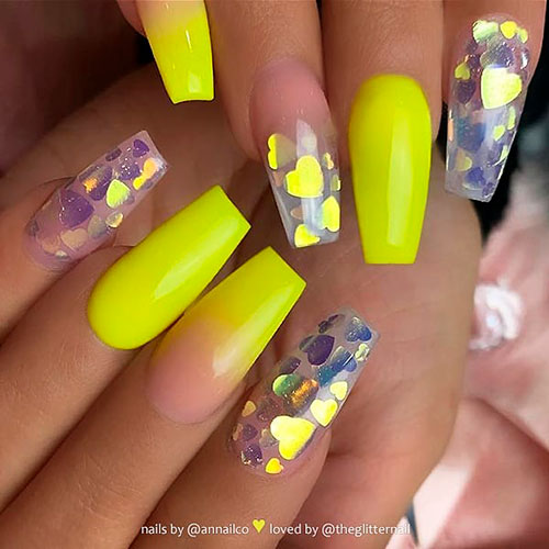 Neon yellow ombre nails with encapsulated glitter hearts on coffin acrylics for summer 2019