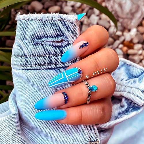 Cute baby blue ombre acrylic nails and baby blue almond nails adorned with navy and silver rhinestones!