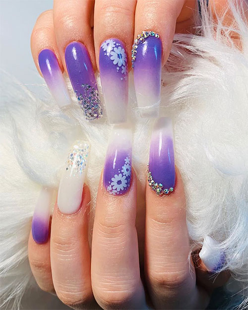 So cute purple ombre nails for summer 2019 adorned with glitter, flowers, and crystals