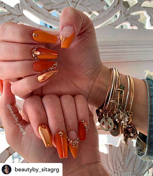 Amazing fall nails 2019 set consists of burnt orange stiletto and coffin shaped nails design adorned with rhinestones