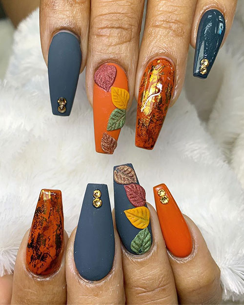 Amazing fall nails consists of gold foil over burnt orange coffin nails