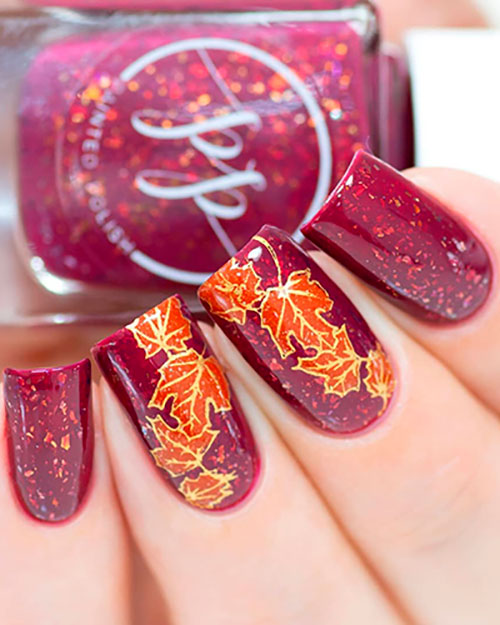 Cute fall nails consists of Leafy Burgundy Nails with glitter