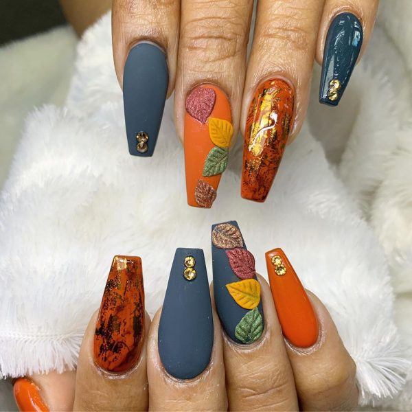 Amazing fall nails consists of gold foil over burnt orange coffin nails