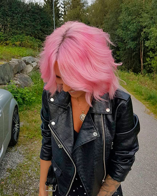 Gorgeous short wavy hair dyed in Pastel Pink Hair color for the Fall season