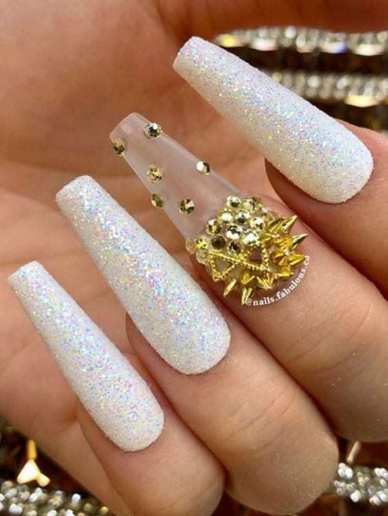 Amazing glitter white winter coffin nails with gold rhinestones on an accent nail!