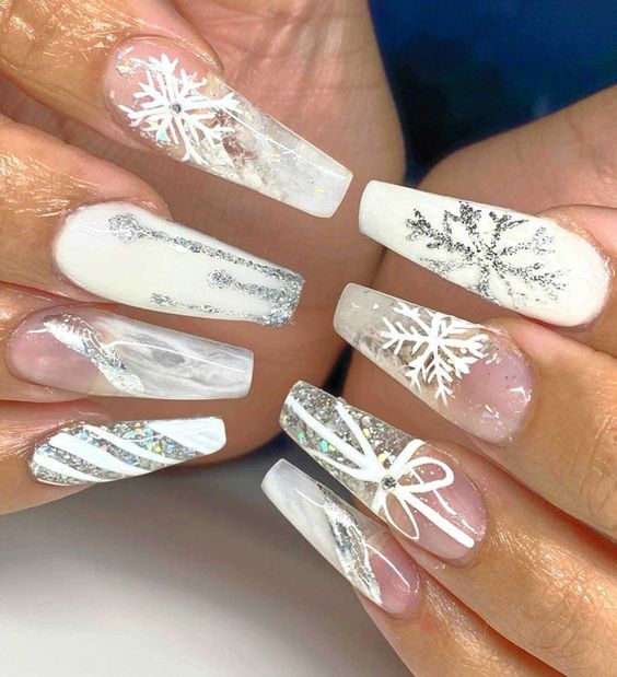 Beautiful long coffin shaped white winter nails with silver glitter snowflakes