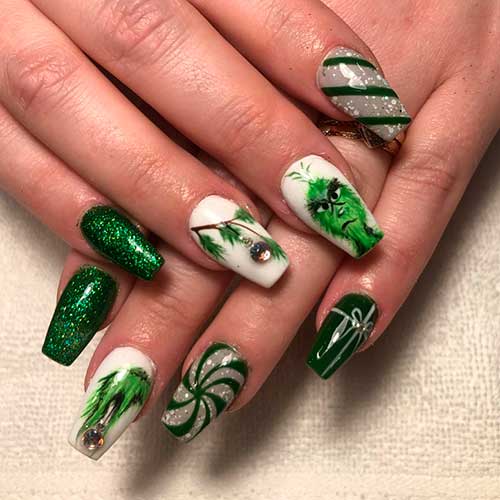 Cute dark green Christmas nails set with green glitter and and Grinch nails!