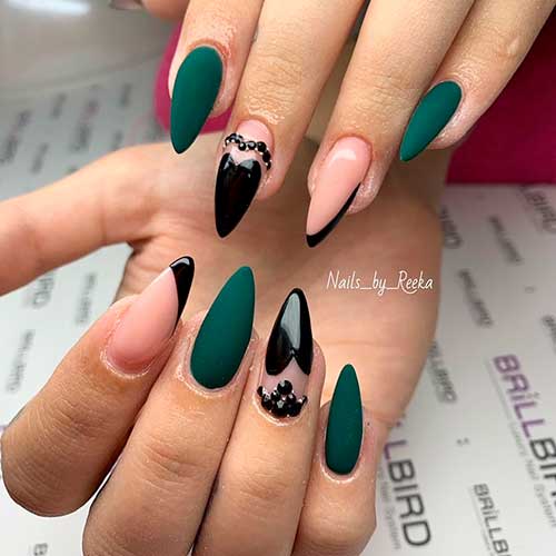 Cute matte dark green and black nail design on long almond nails set! Cute matte dark green and black nail design on long almond nails set!