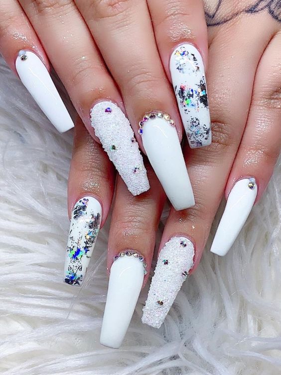 Cute white winter nails coffin shaped long with glitter, foil, and rhinestones!