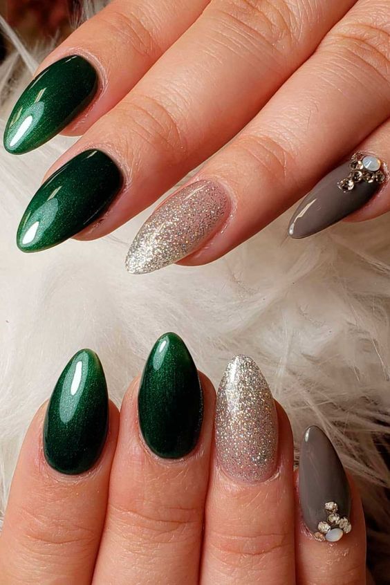 Fancy almond shaped dark green nails with glitter and rhinestones!
