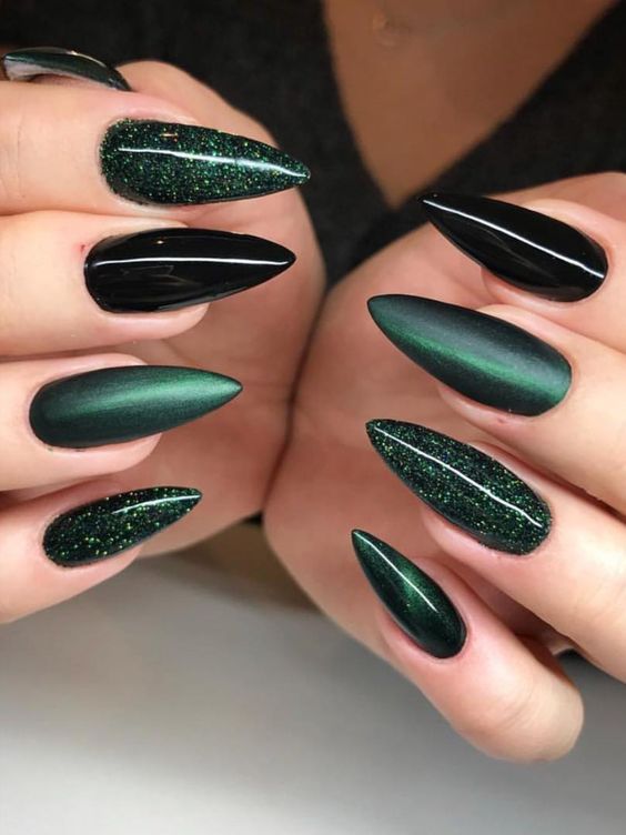Gorgeous dark green and black nails stiletto shaped set with glitter!