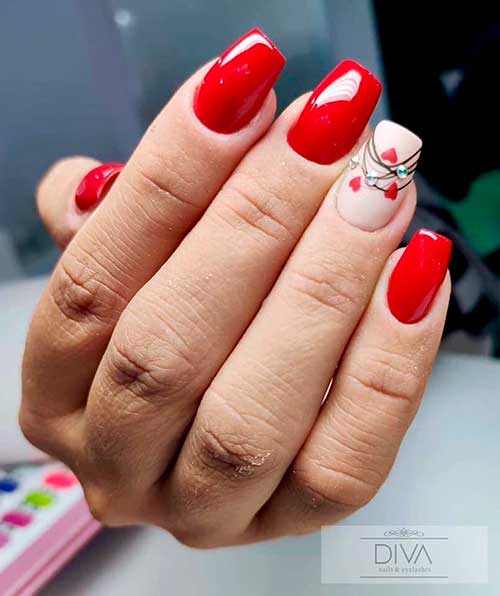 Cute red valentines day nails design! Red valentines day nails coffin shaped with accent nude nail adorned with red hearts and rhinestones