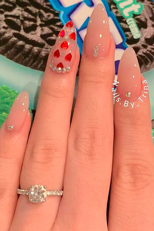 Nude Color Valentines Day Nails Almond Shaped with Rhinestones and Red Hearts On Accent Clear Nail