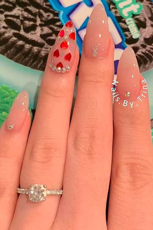 Nude Color Valentines Day Nails Almond Shaped with Rhinestones and Red Hearts On Accent Clear Nail Nude Color Valentines Day Nails Almond Shaped with Rhinestones and Red Hearts On Accent Clear Nail