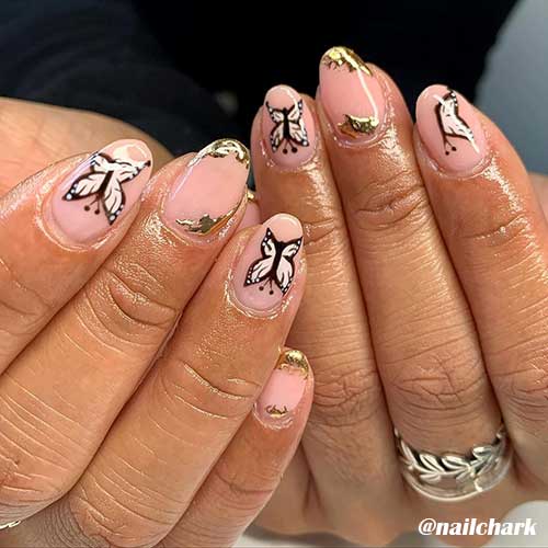 Amazing butterfly nails art on almond nude nails and adorned with gold foil