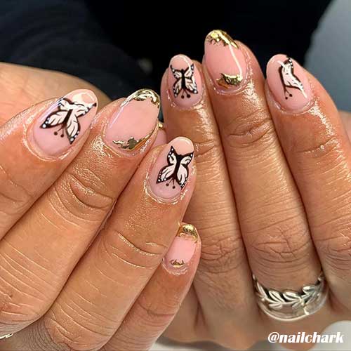 Amazing butterfly nails art on almond nude nails and adorned with gold foil Amazing butterfly nails art on almond nude nails and adorned with gold foil