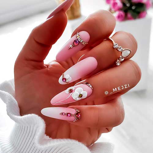 Cute almond pink floral nails art with rhinestones, 3d flowers, and two accent pink ombre nails design!