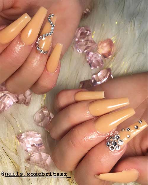 Cute coffin nails nude long shaped with silver rhinestones on accent nail