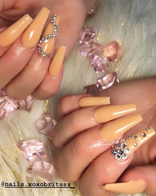 Cute coffin nails nude long shaped with silver rhinestones on accent nail Cute coffin nails nude long shaped with silver rhinestones on accent nail