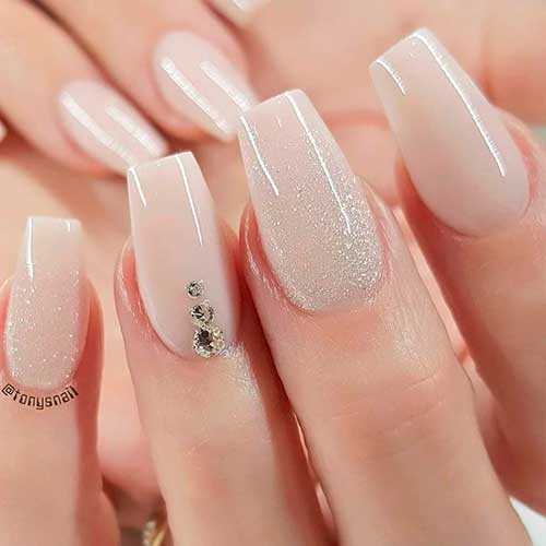 Cute nude nails with glitter and rhinestones design!