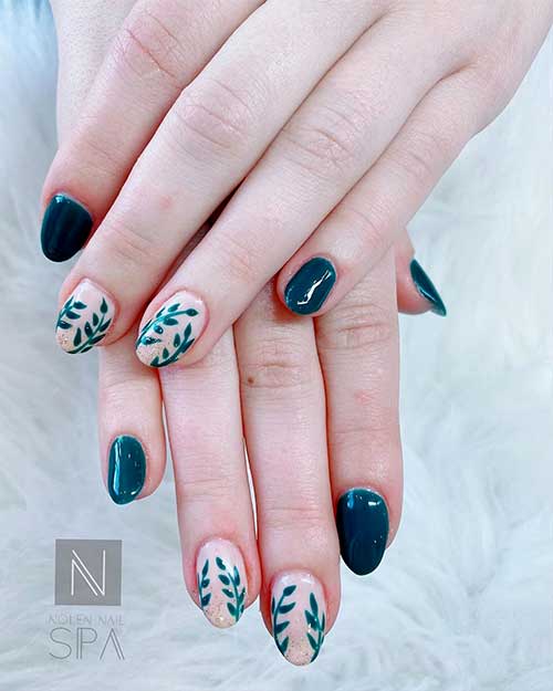 Cute short almond acrylic nails 2020 for spring season consists of dark teal nails and teal leaves on nude almond nails